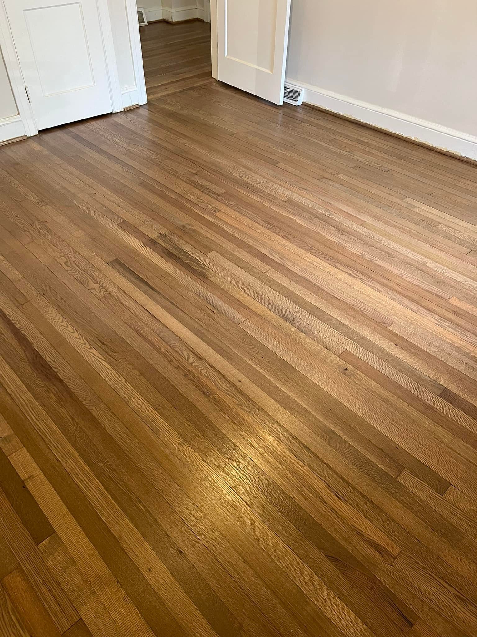 A room with a wooden floor and white walls.