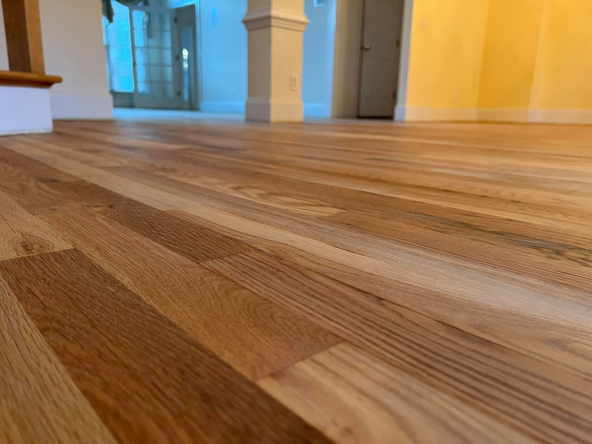 A close up of a wooden floor in an empty room.