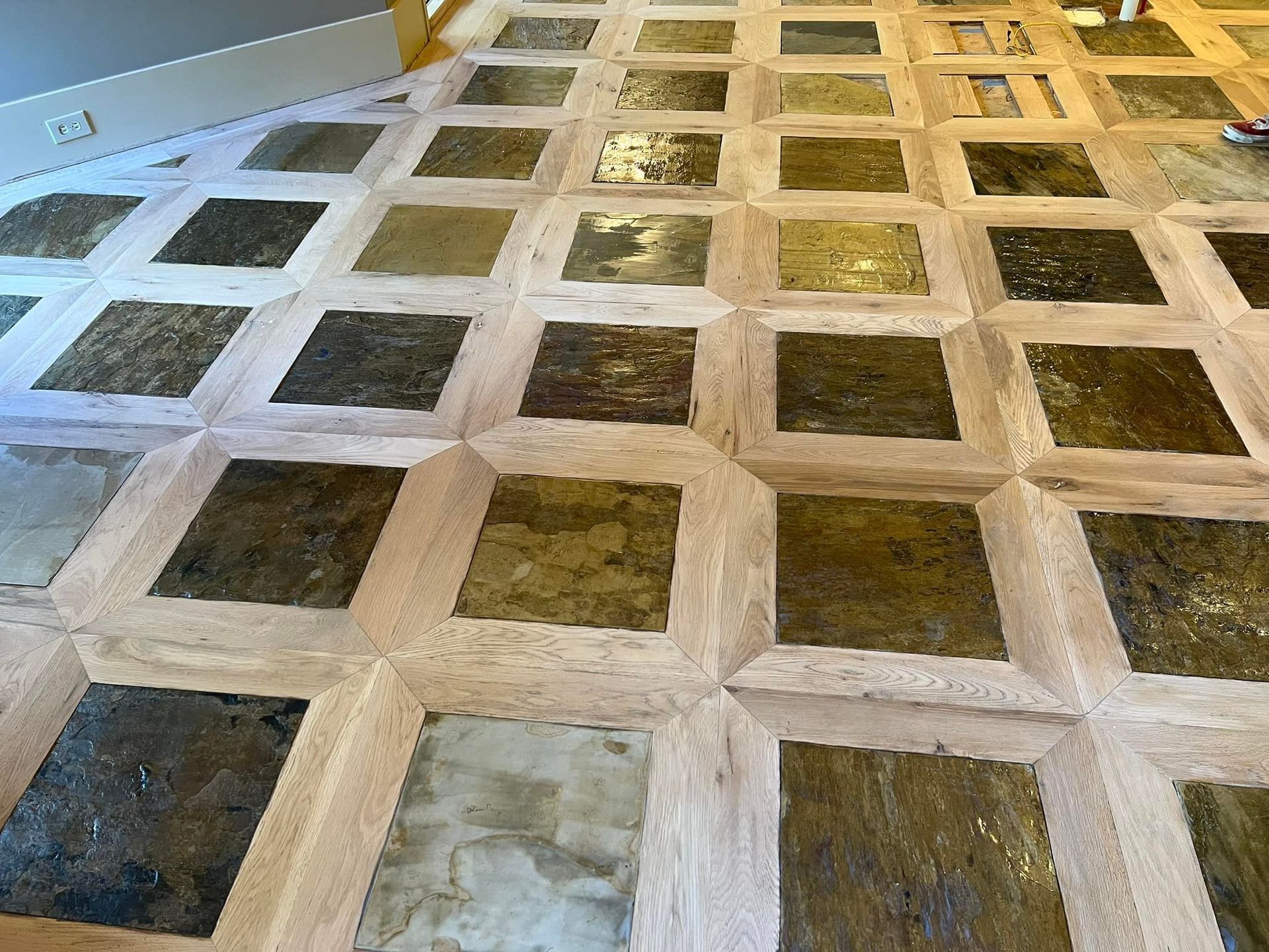 A wooden floor with a pattern of squares on it.