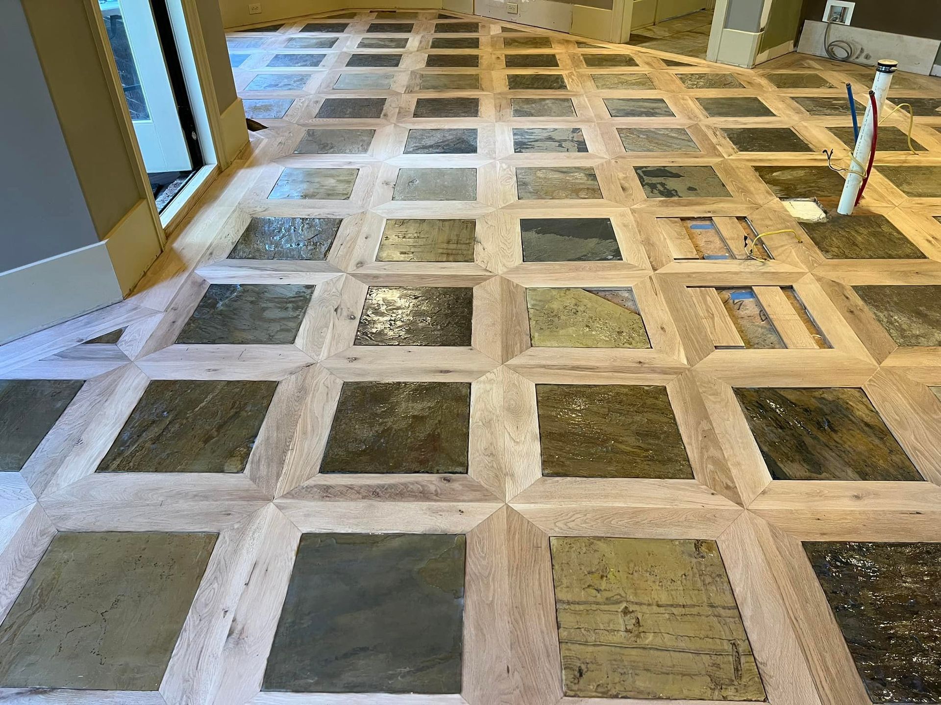 A wooden floor with a pattern of squares on it