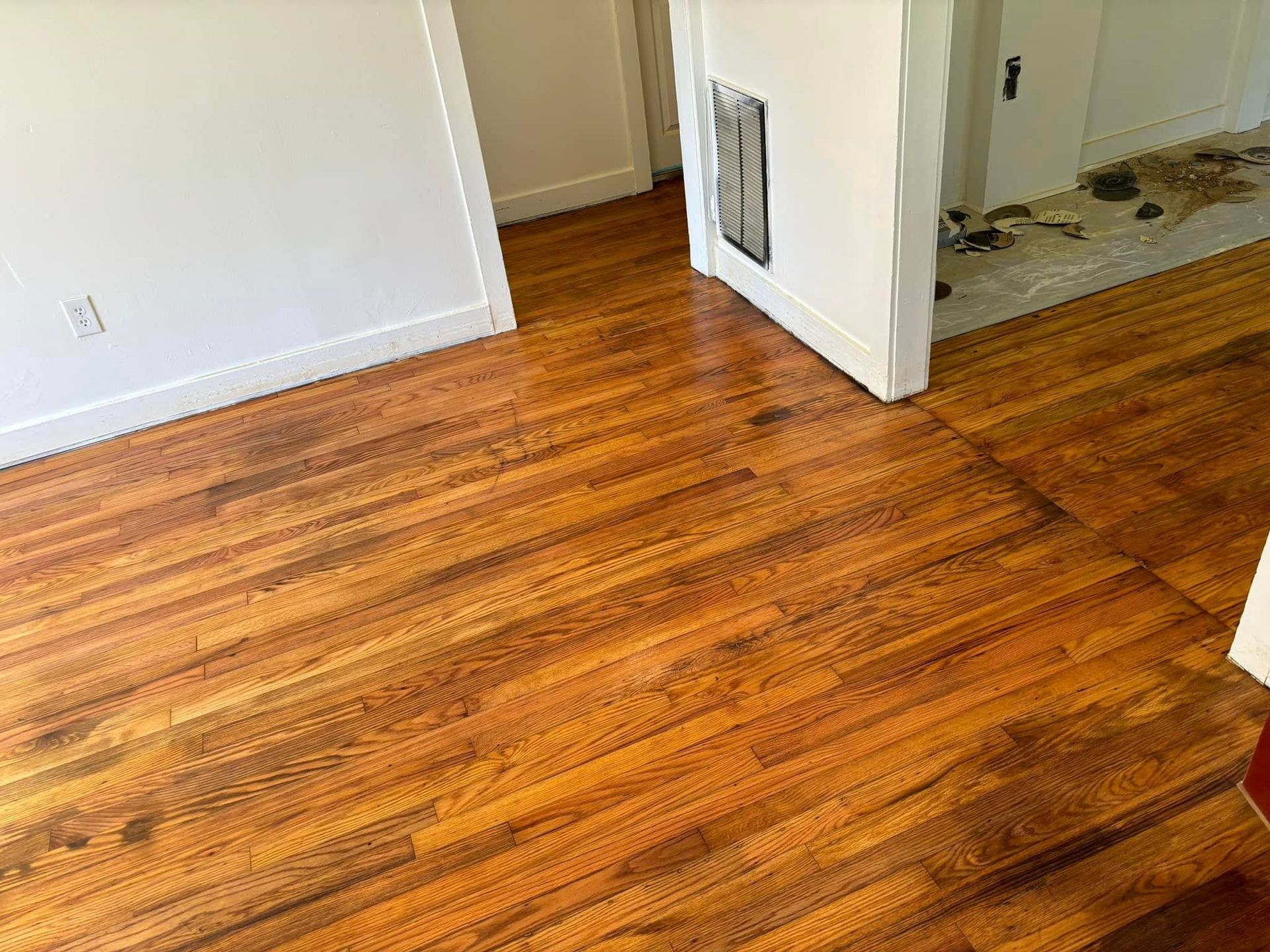 A room with hardwood floors and white walls.