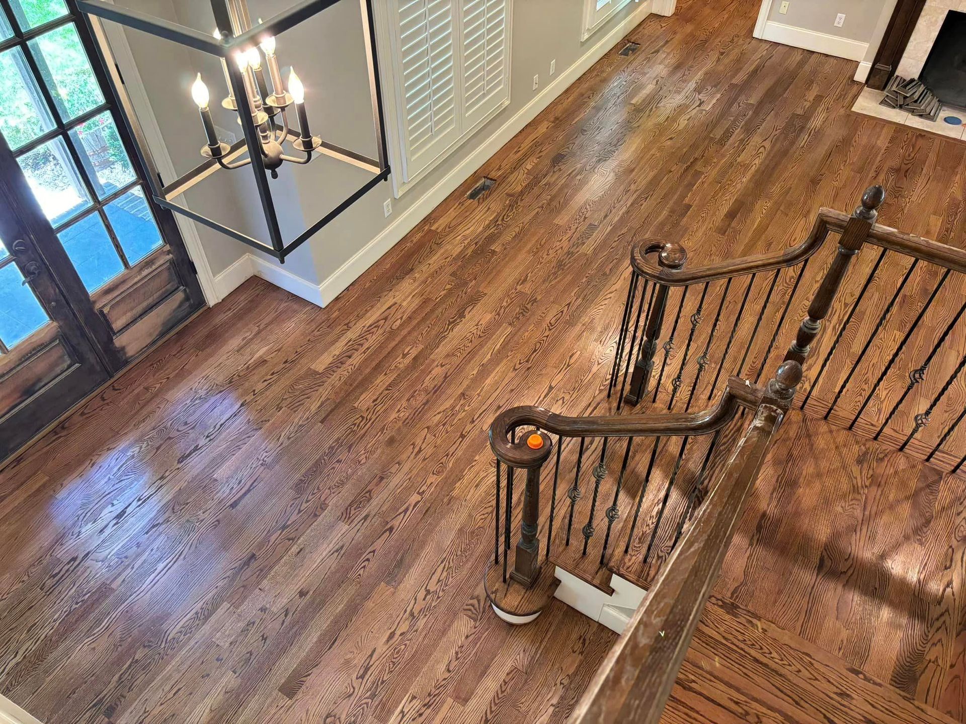 An aerial view of a wooden staircase in a house.