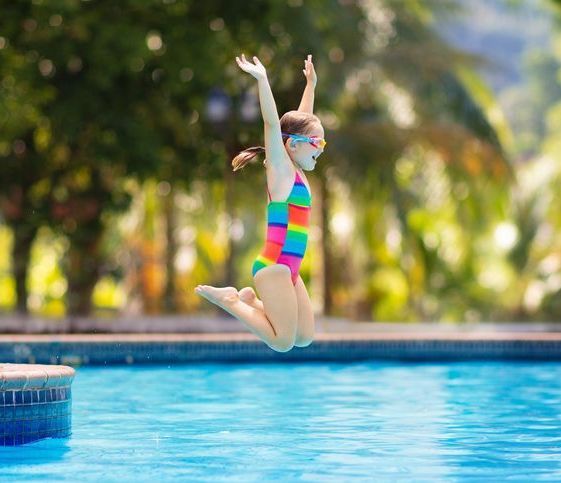 Child in swimming pool on toy ring