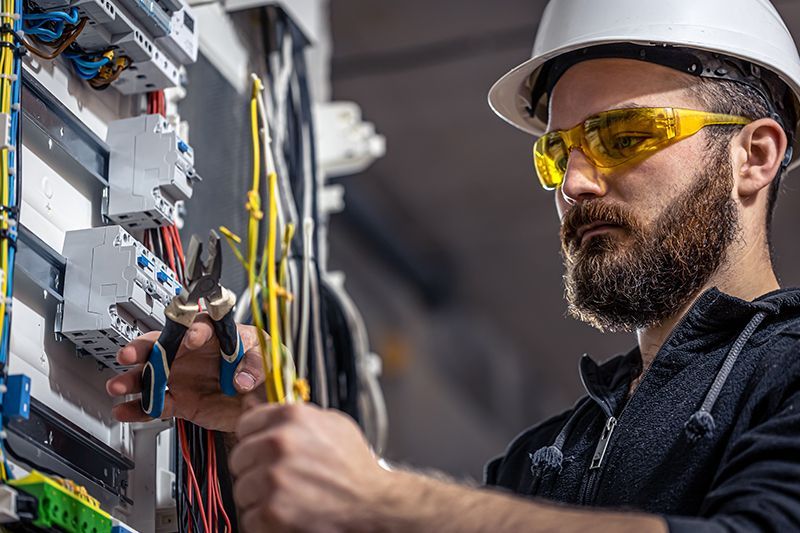 Electrician Repairing The Switchboard