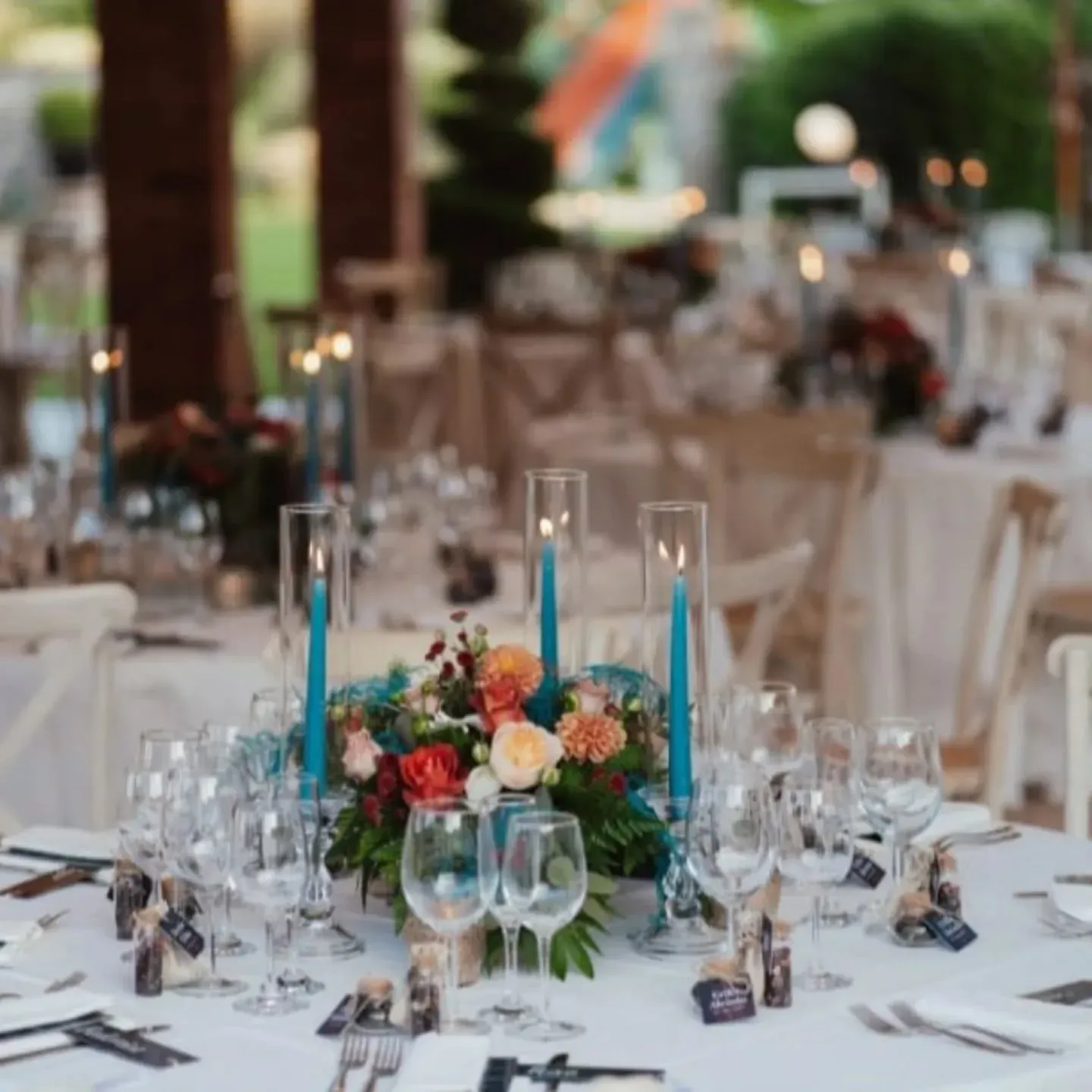 Un tavolo apparecchiato per un ricevimento di nozze con fiori e candele