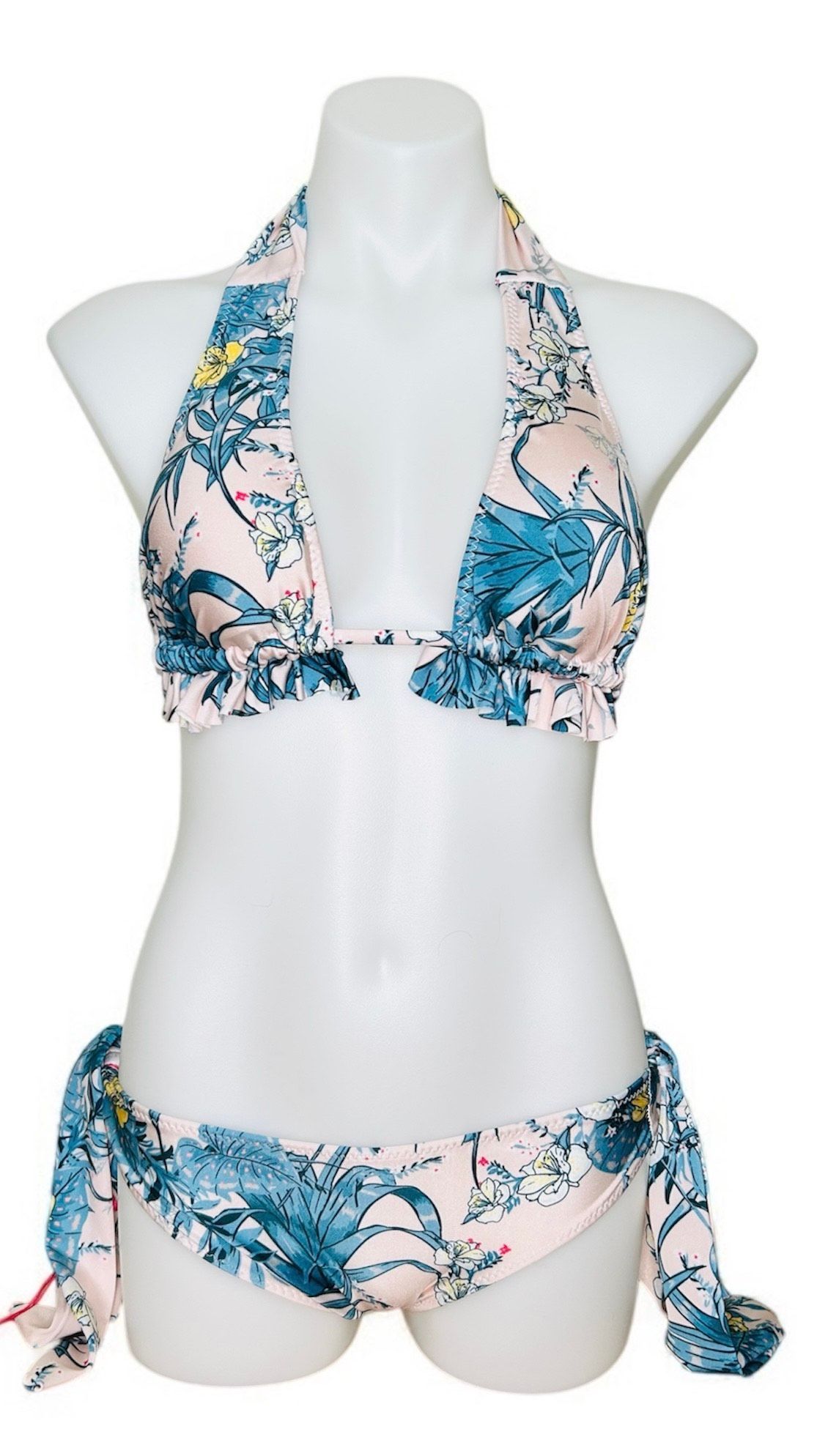 A woman in a bikini is standing on a beach.