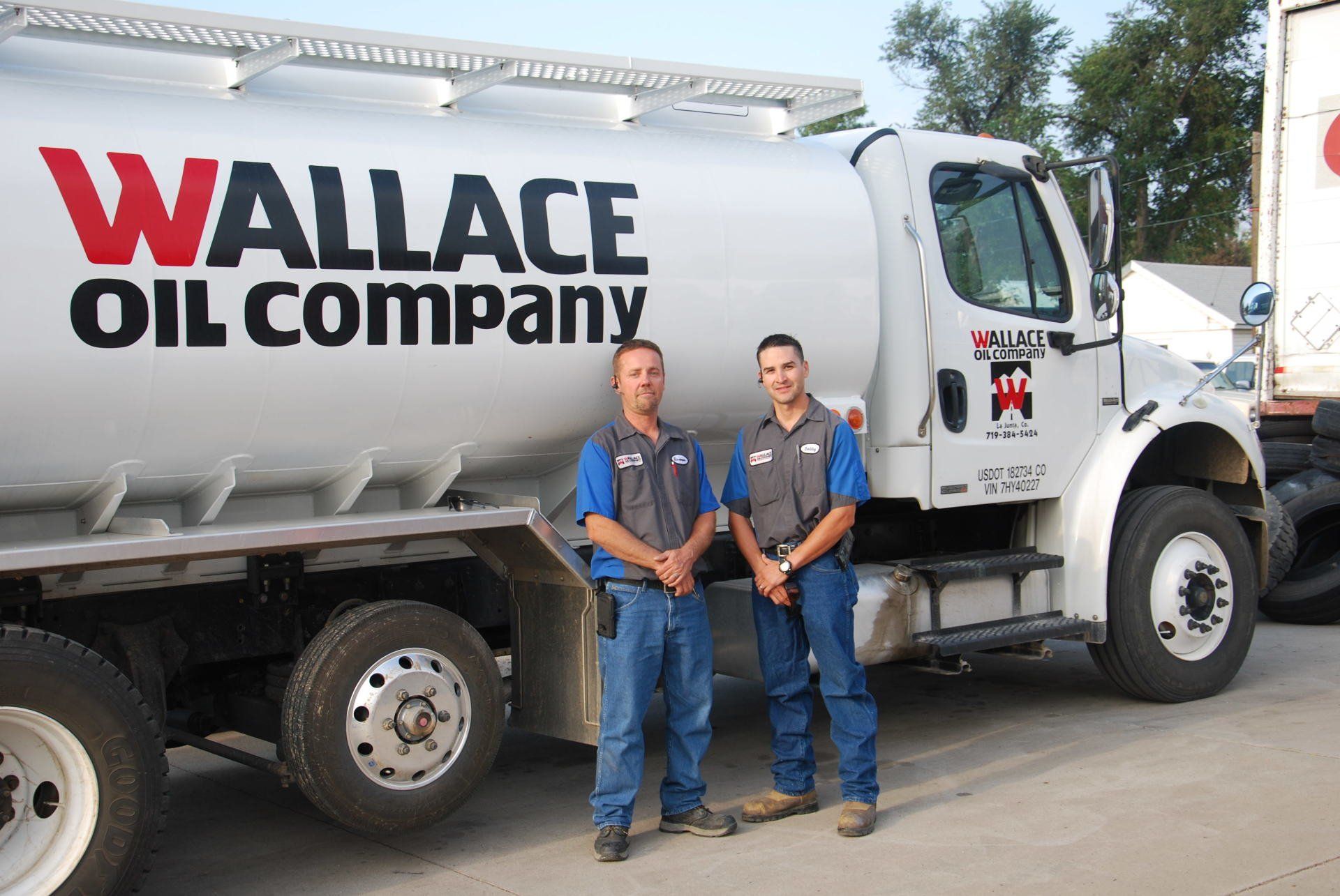 professionals standing in front of Wallace Oil Company truck