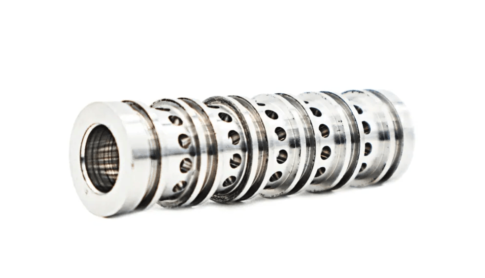A close up of a row of bearings on a white background.