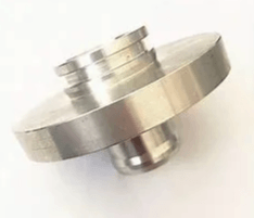 A close up of a metal object on a white surface.