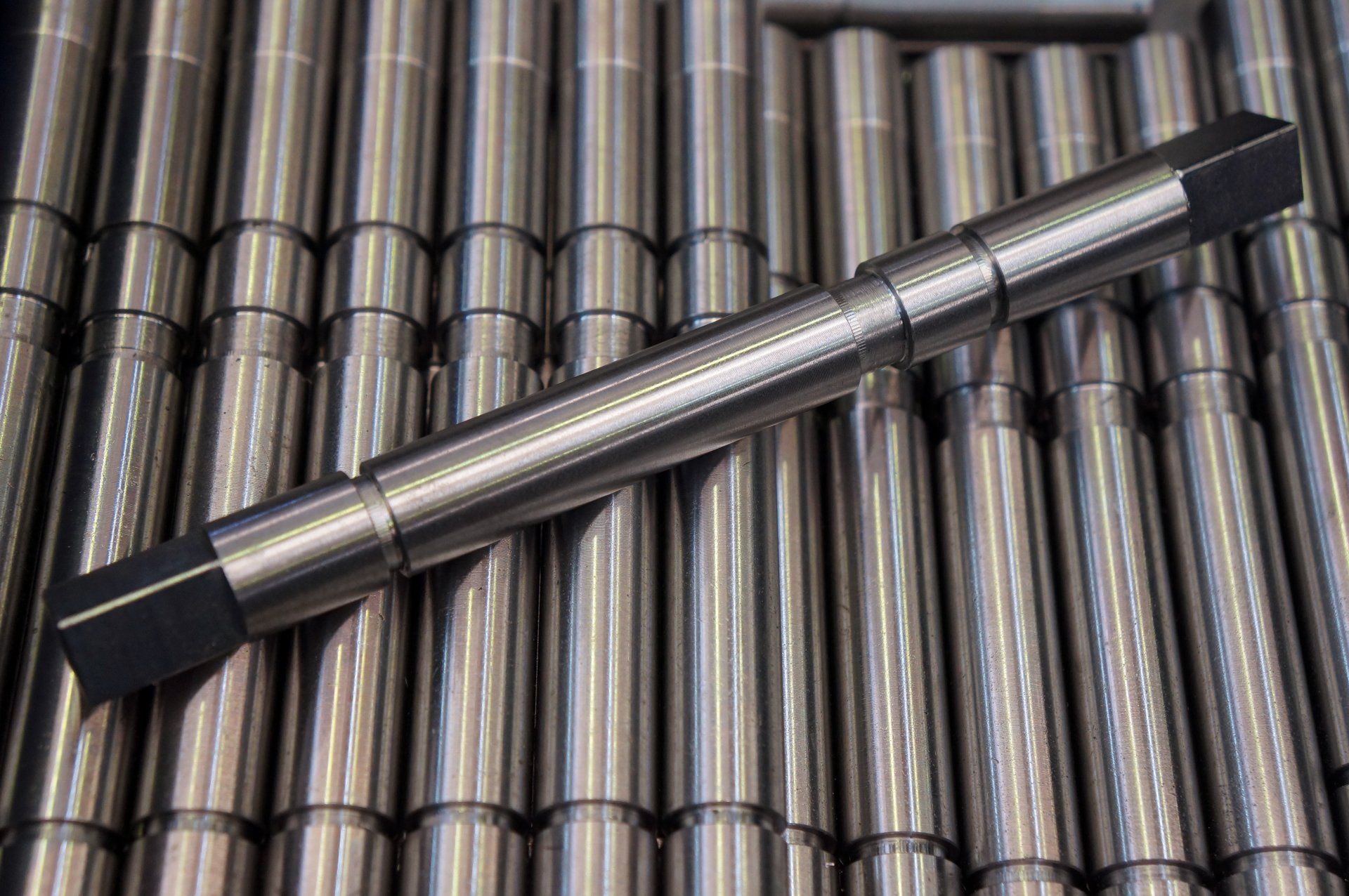 A pen is sitting on top of a pile of metal rods.
