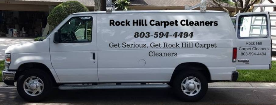 White van for Rock Hill Carpet Cleaners parked on a road with its rear door open.