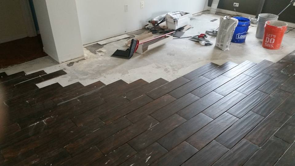 A wooden floor is being installed in a room.