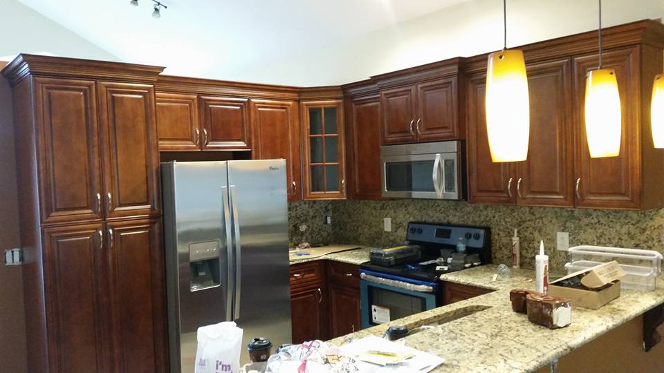 A kitchen with stainless steel appliances and wooden cabinets