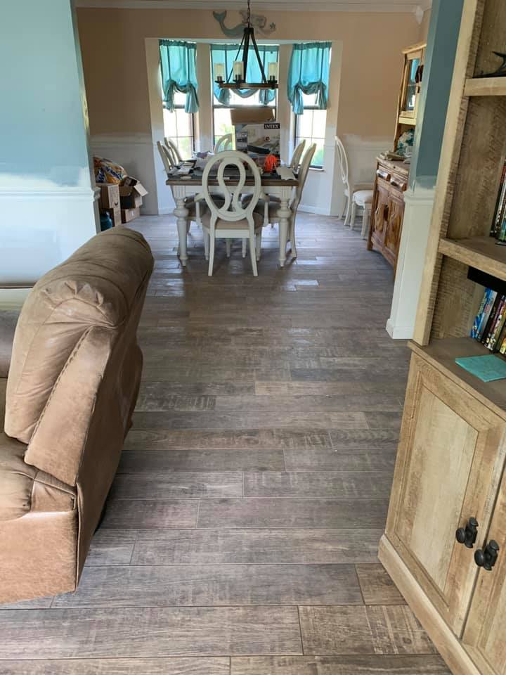 A living room with a dining room table and chairs and a couch.