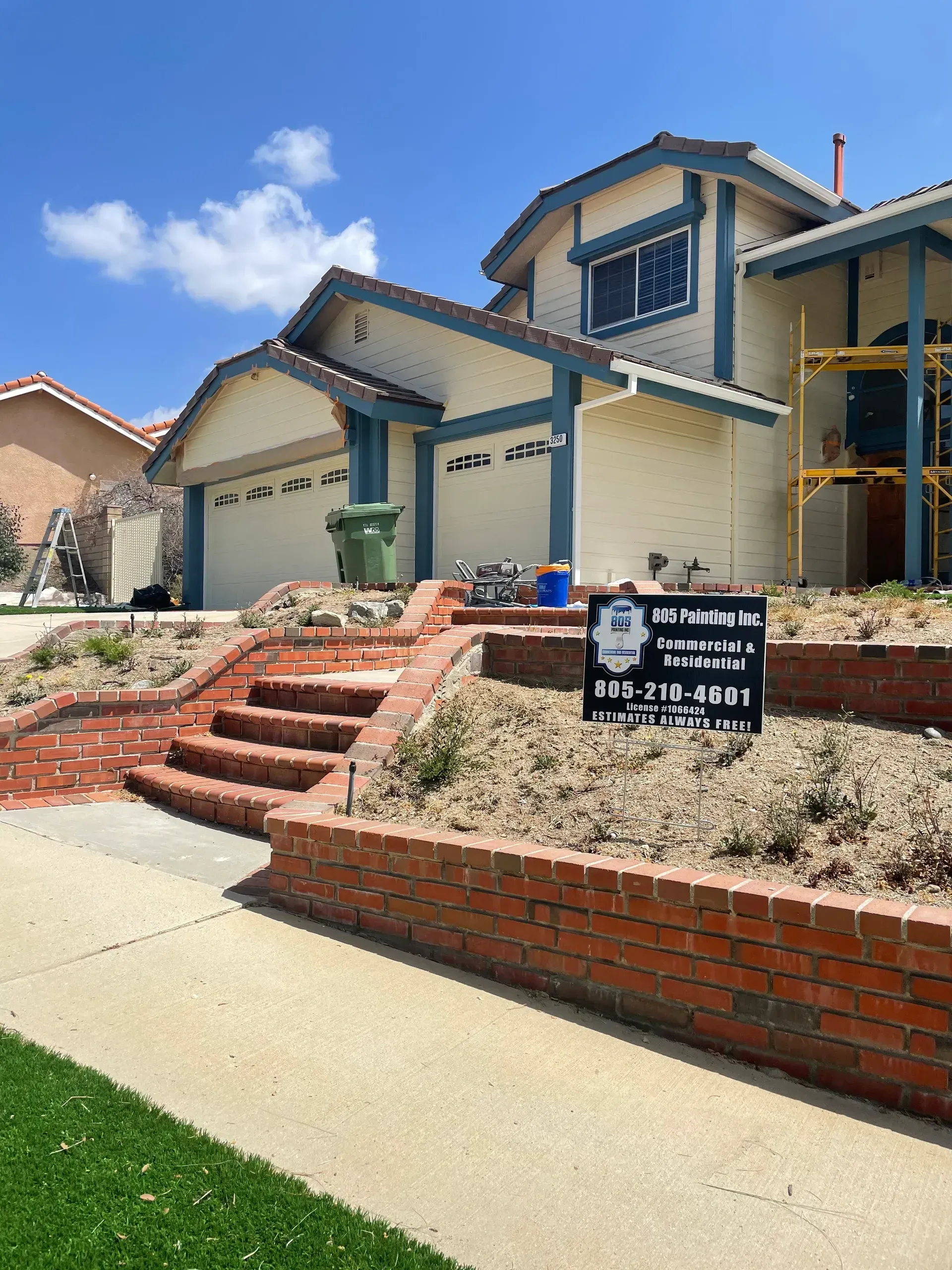 A house with stairs and a sign in front of it