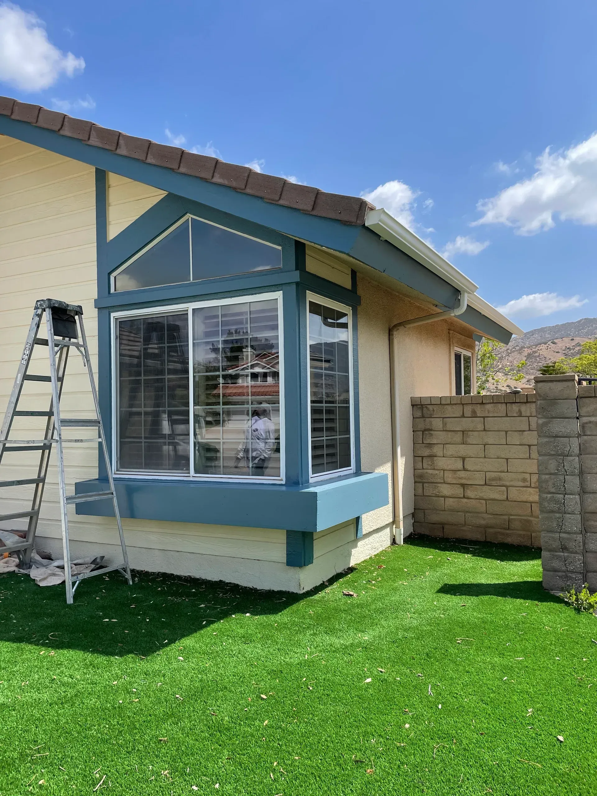 A house with a ladder on the side of it