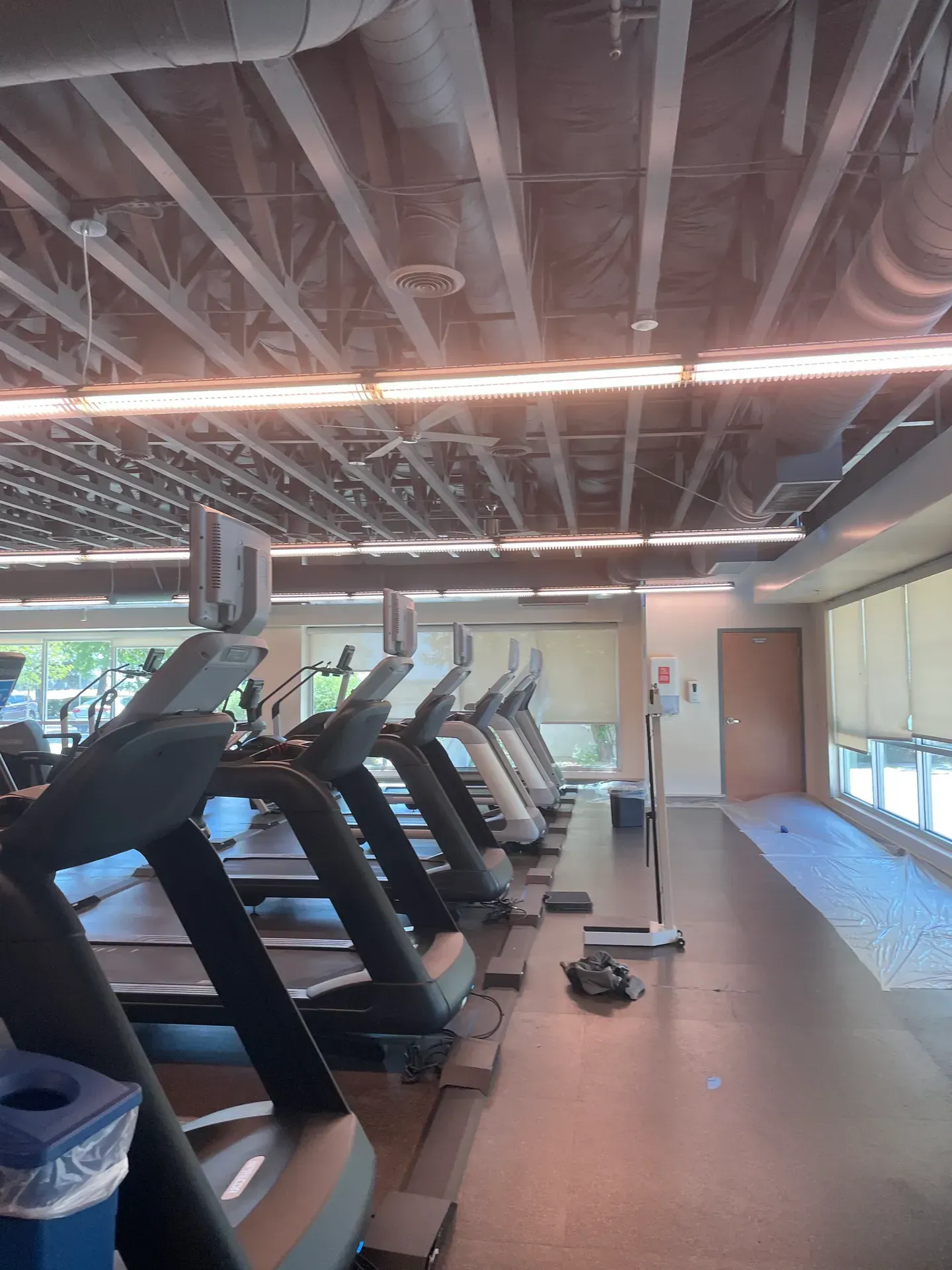 A gym with a lot of treadmills in it