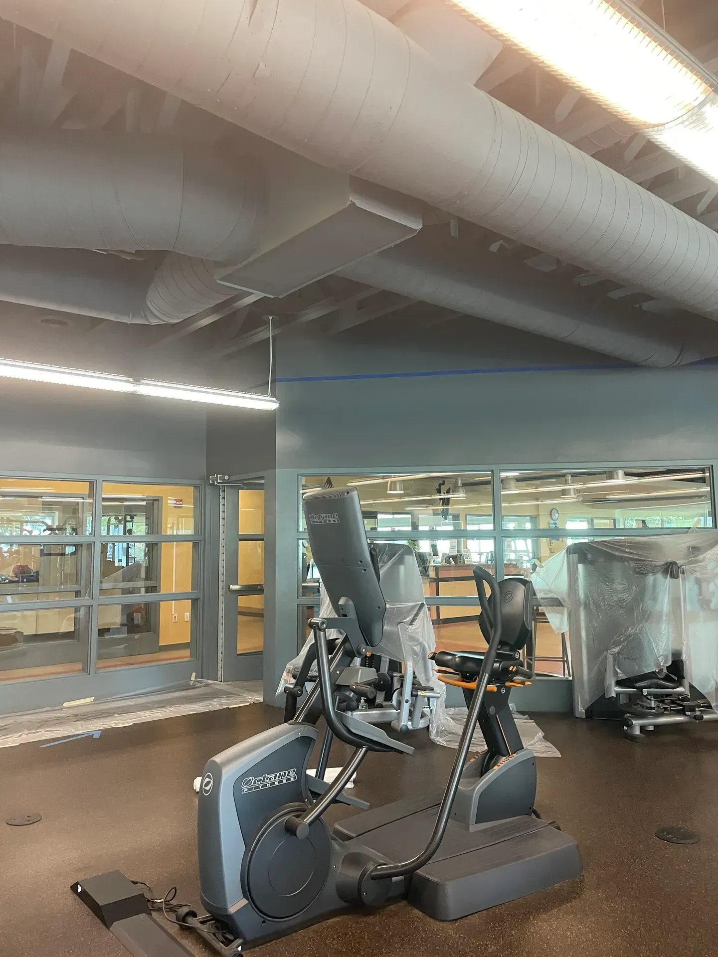 A gym with a bicycle and a treadmill in it