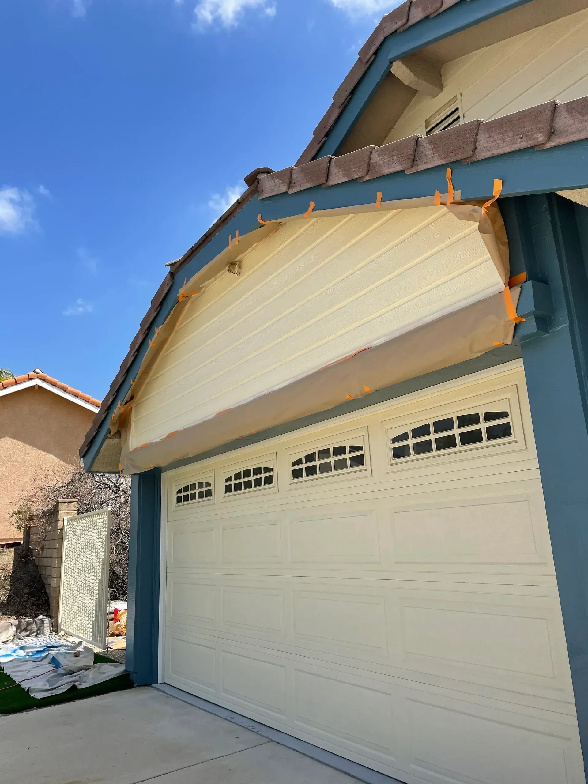 A house with a white garage door and blue trim