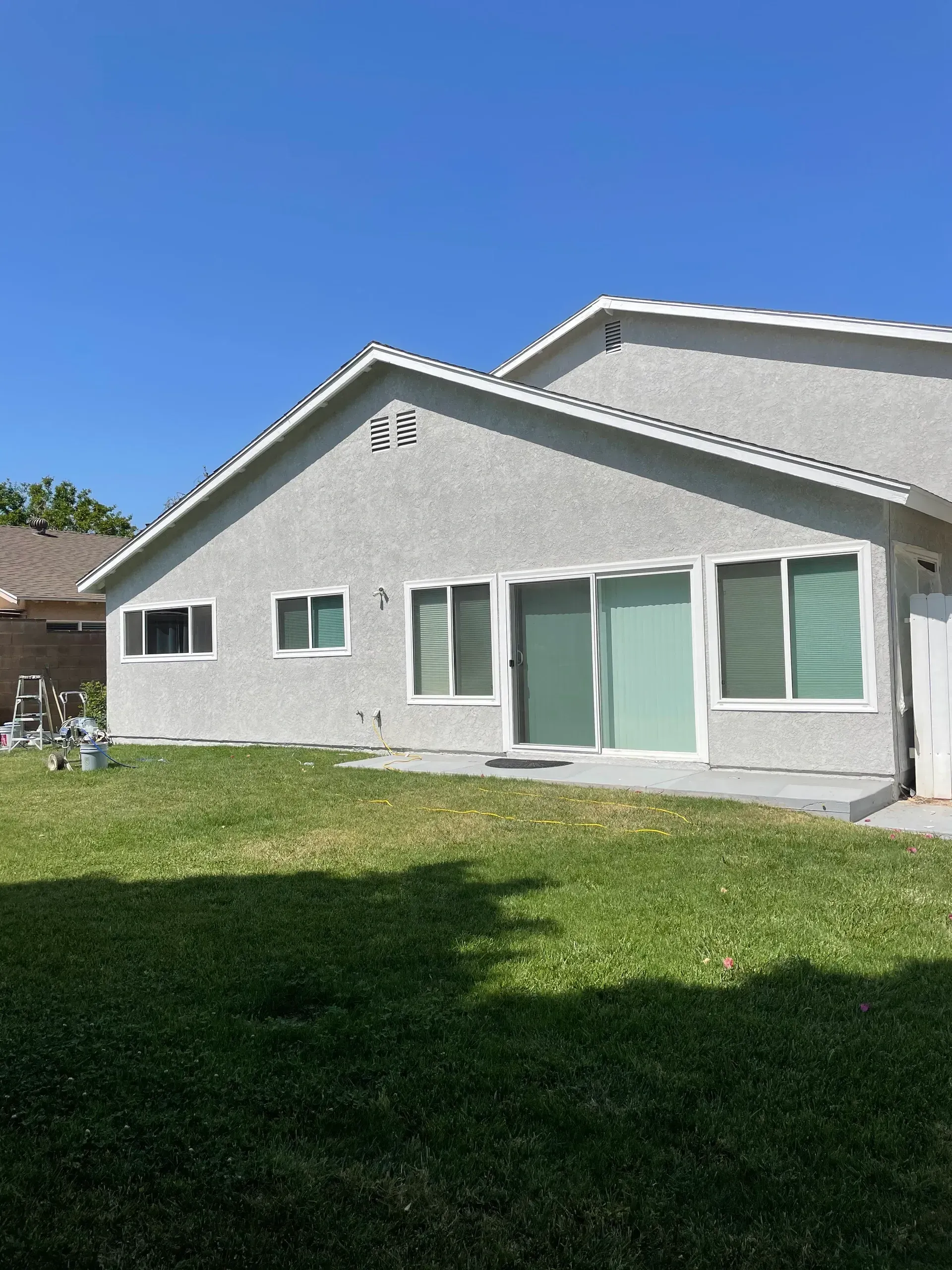 A house with a lot of windows and sliding glass doors