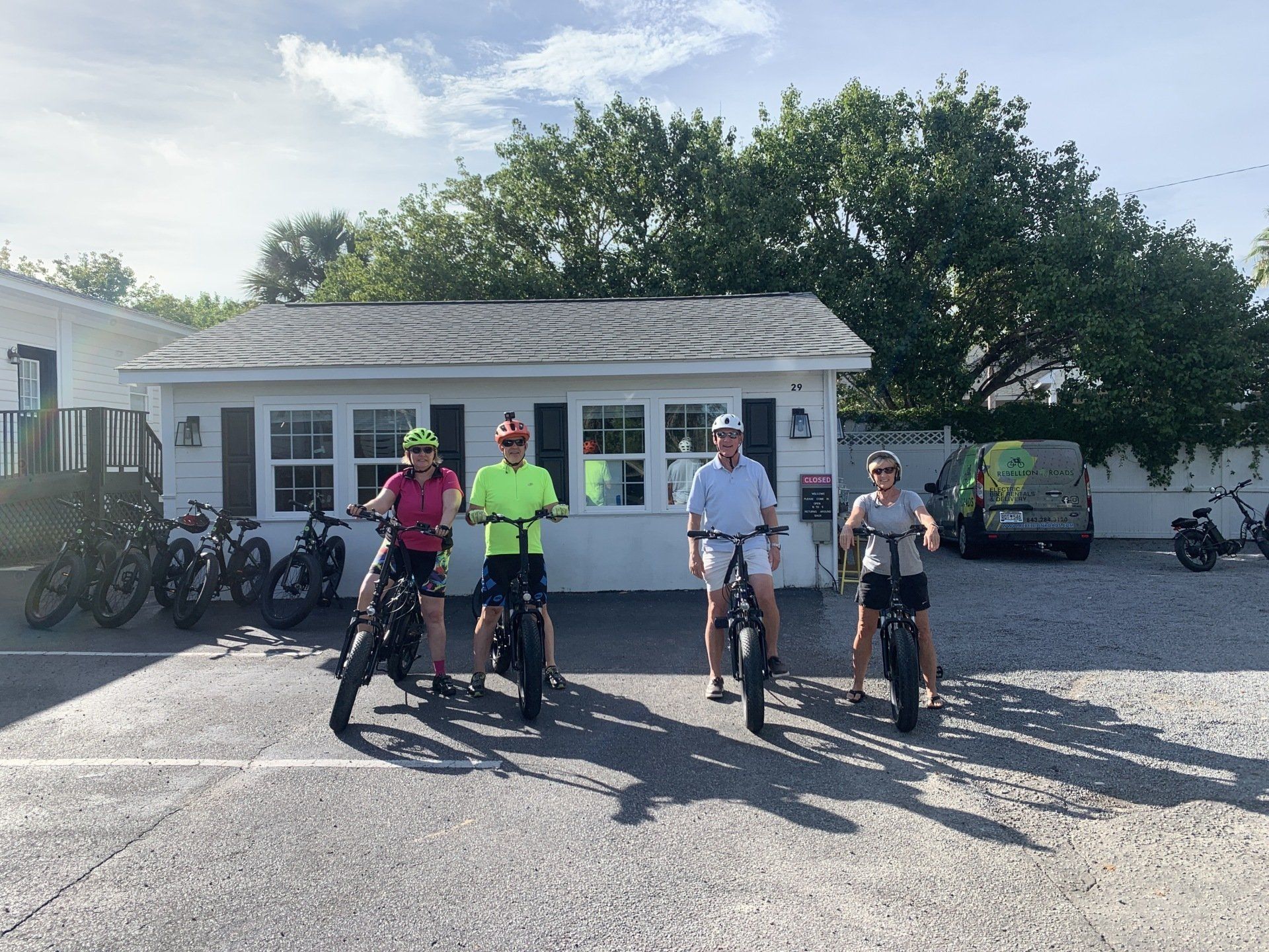 Group of people smiling with on their bike