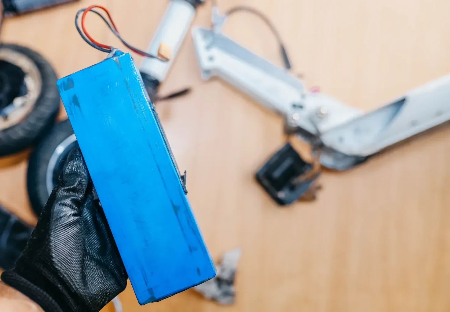 A person fixing an e-bike battery in their hand.