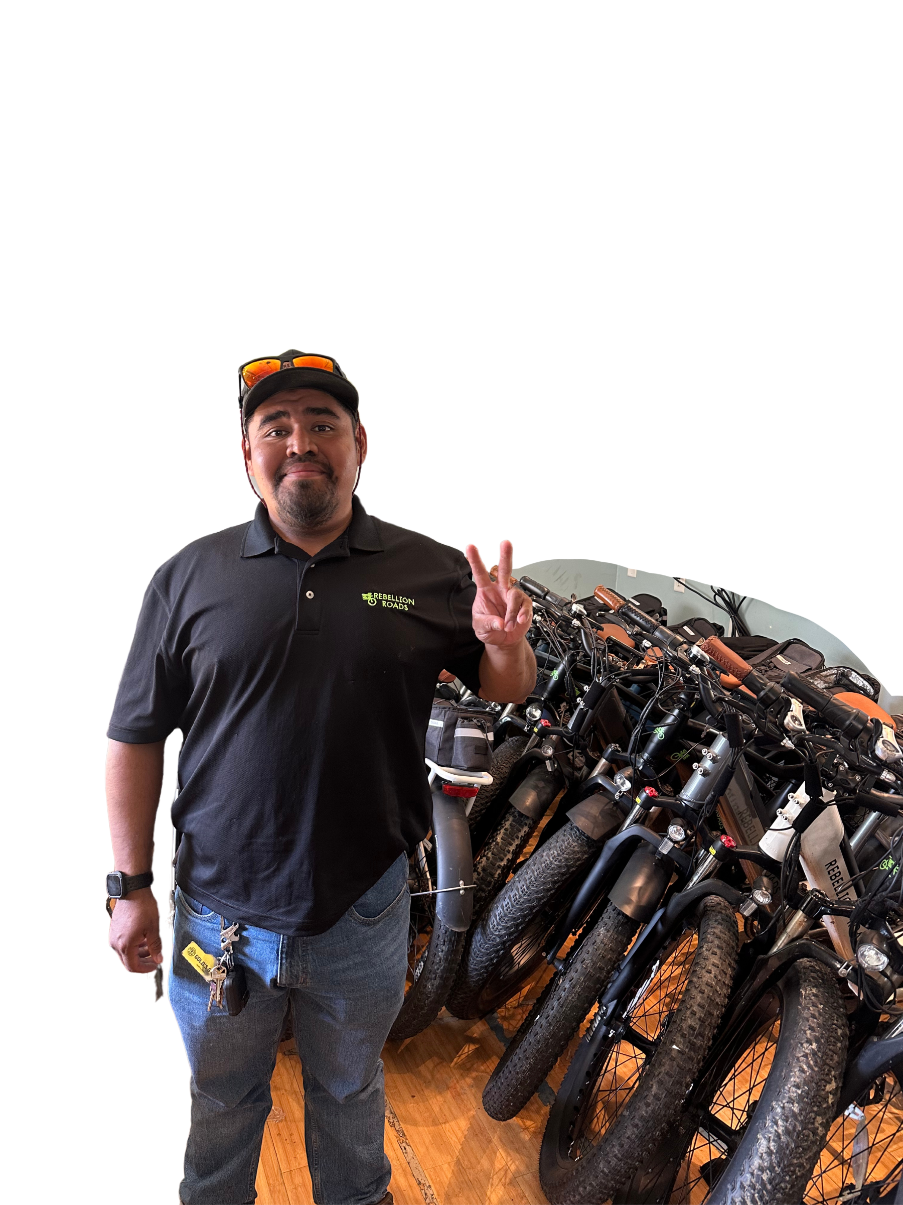 a man is standing in front of a row of bikes .