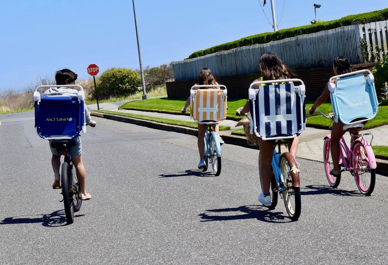 A group of people riding bikes with beach chairs at Isle of Palms