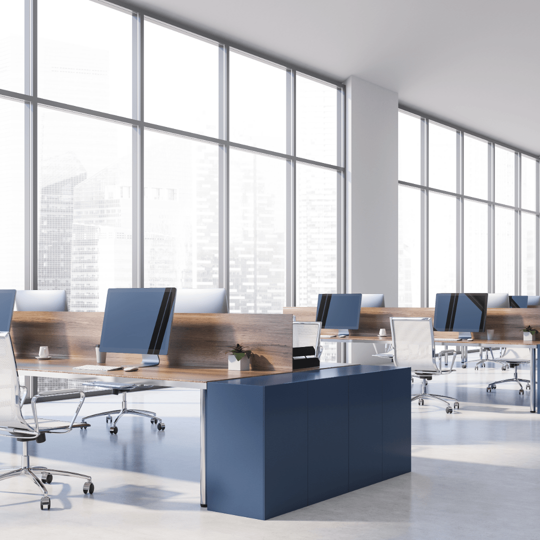 A large office with lots of windows and blue chairs.