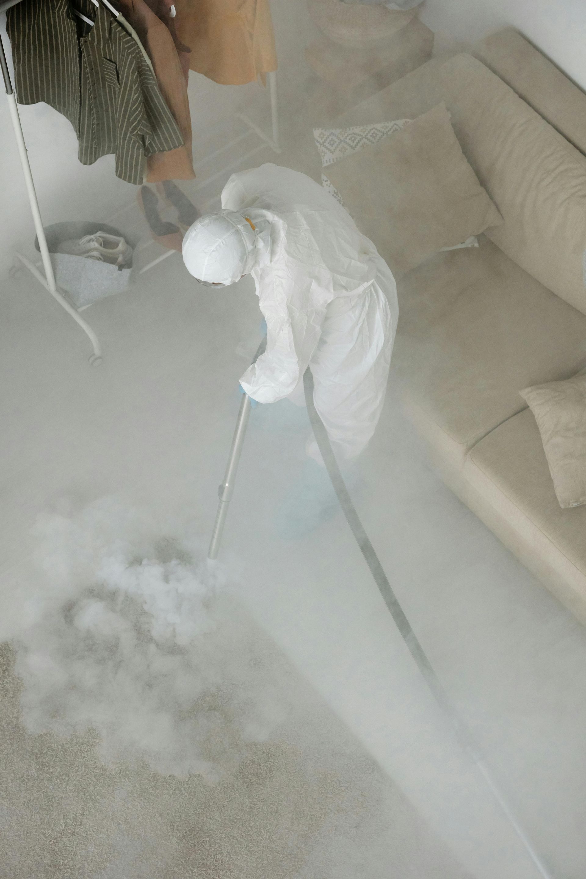A person is cleaning a carpet with a vacuum cleaner in a living room.