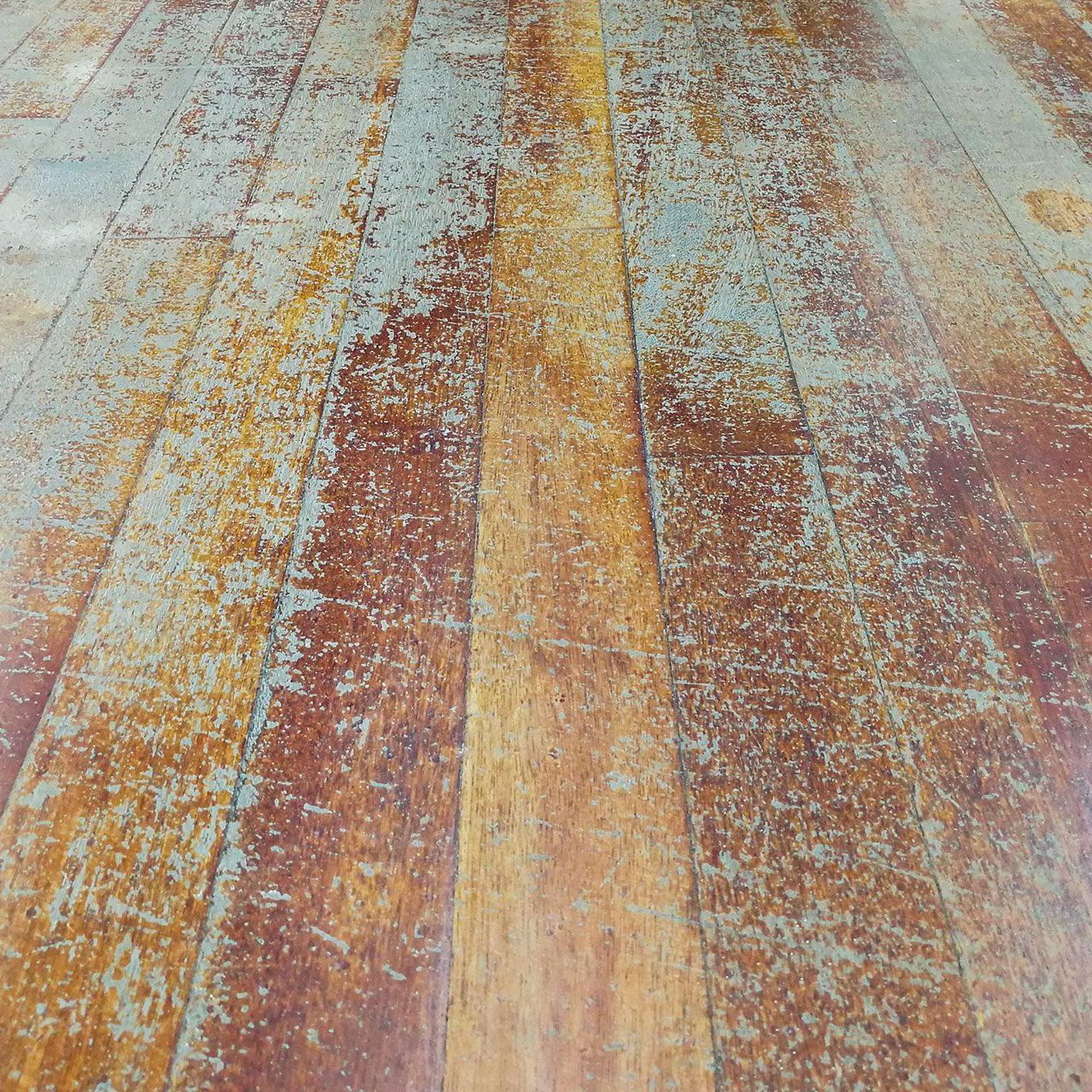 A wooden floor with a lot of scratches on it