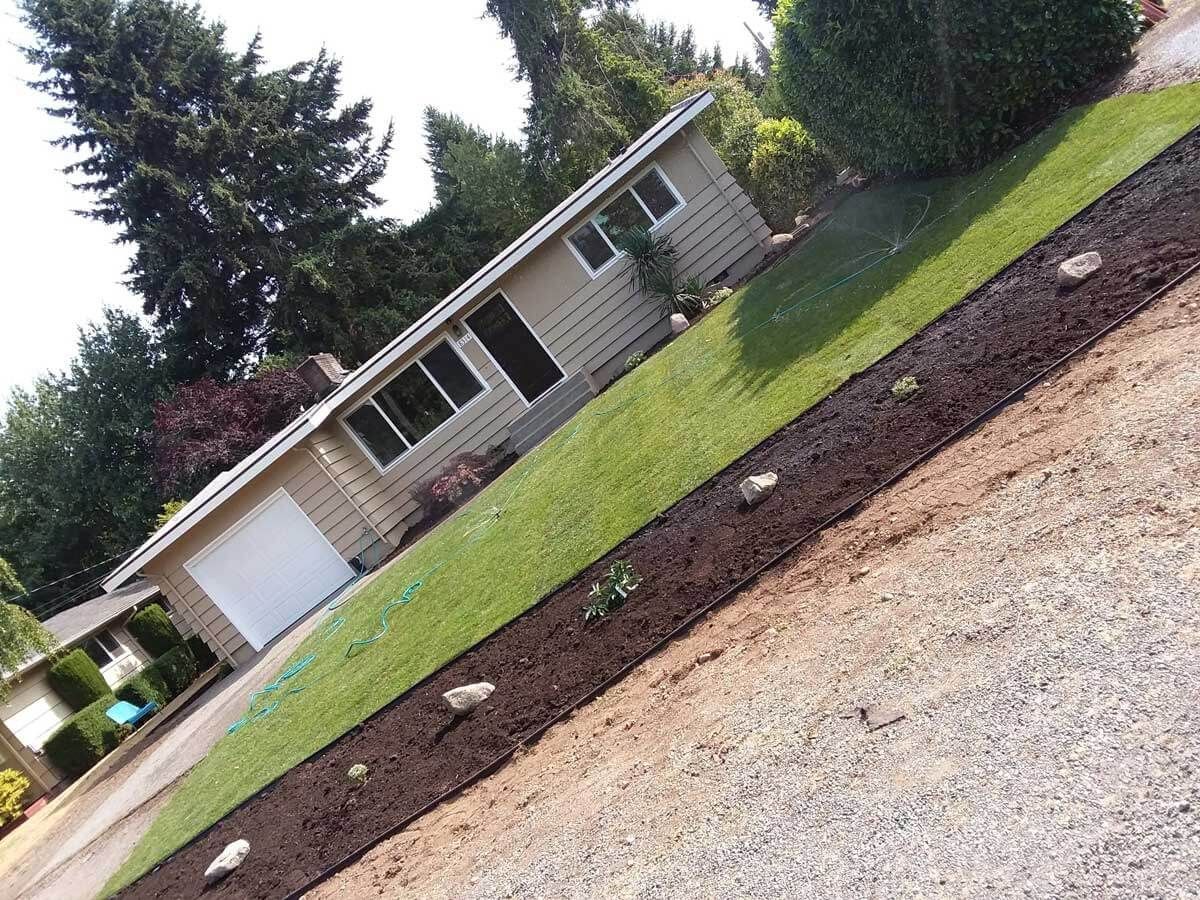 A house with a gravel driveway in front of it