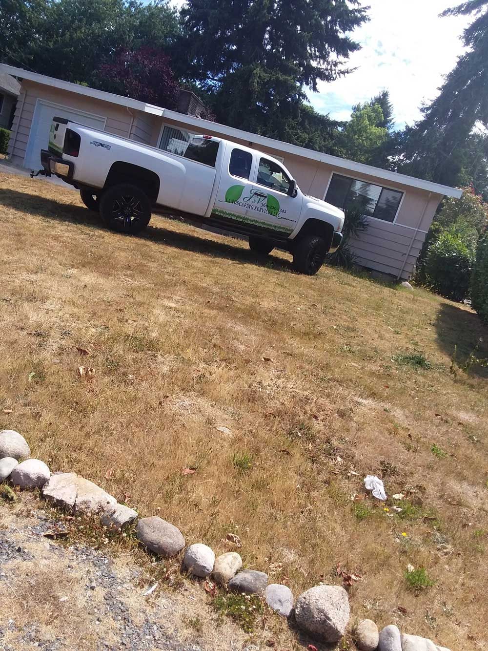 A white truck is parked in front of a house.