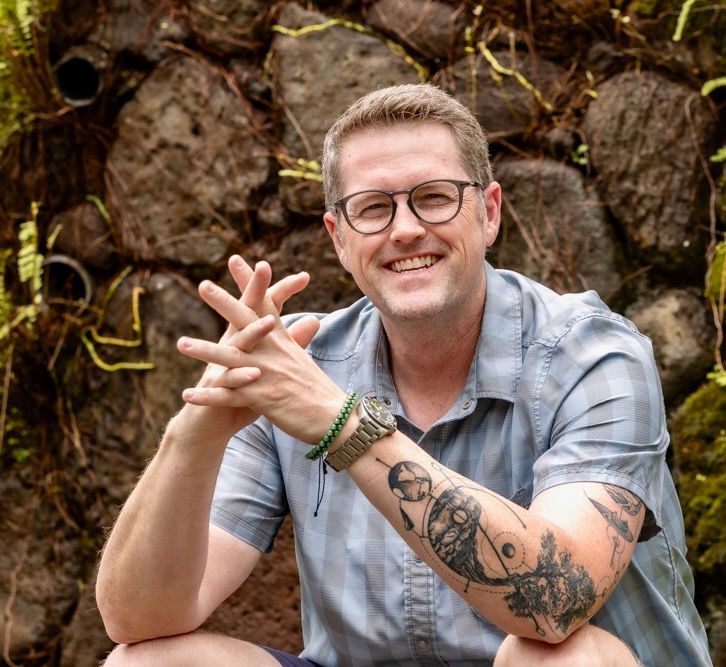 Close up of a man smiling and wearing glasses