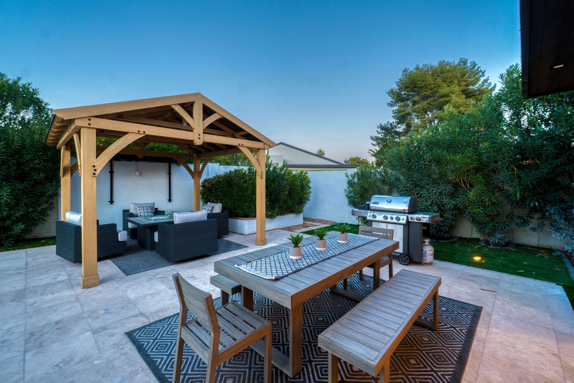 Outdoor table and chairs on a luxurious backyard patio.