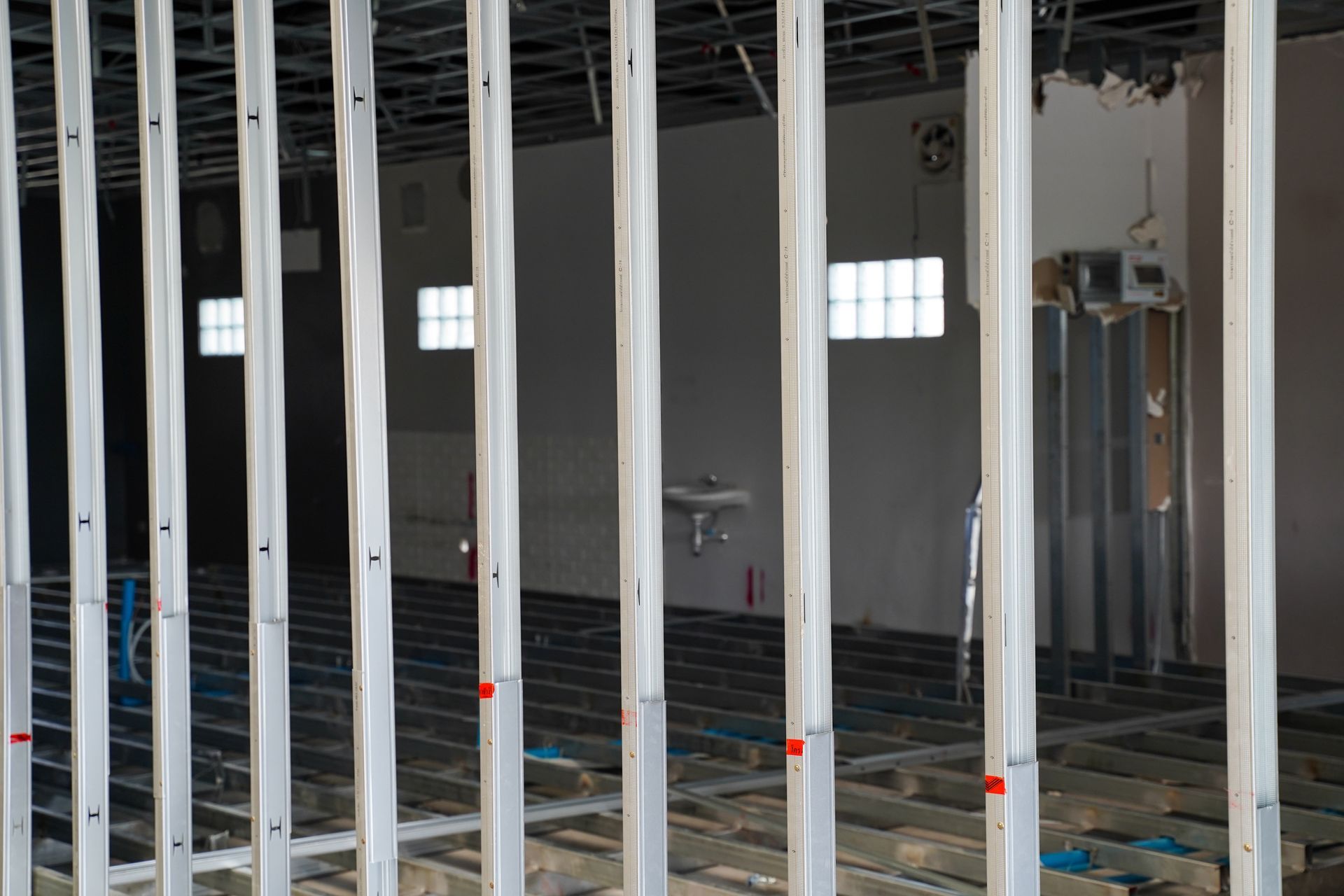 Construction workers renovating an office space in a commercial building.