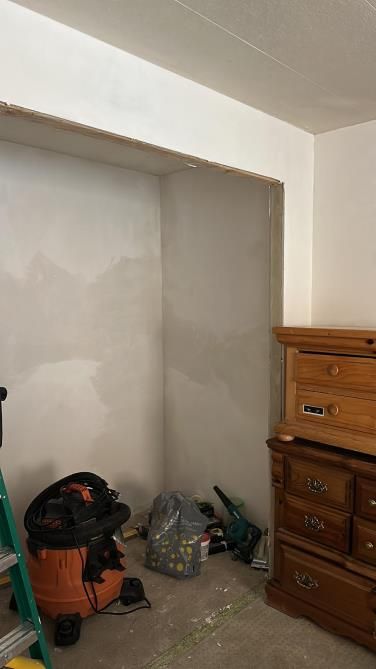 a vacuum cleaner sits in a room that is being remodeled