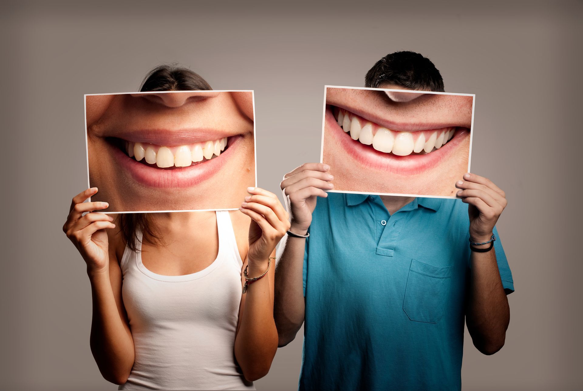 Couple holds giant smiles at their family dentist to show off healthy, bright white teeth.