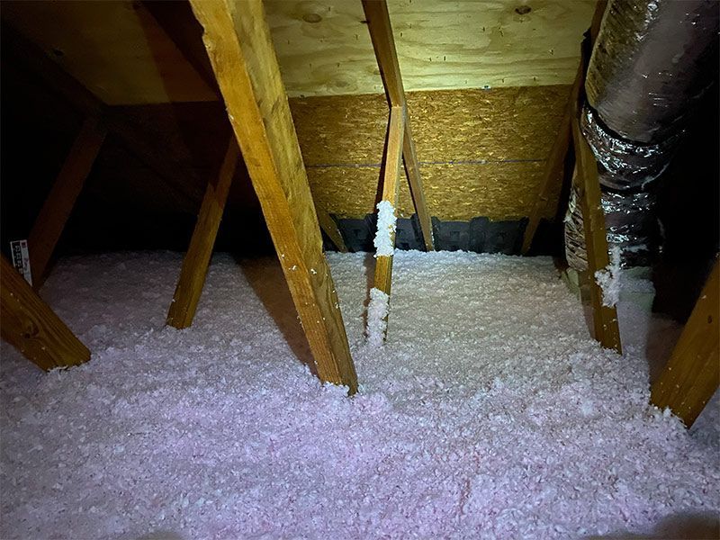 There is a lot of insulation in the attic of a house.