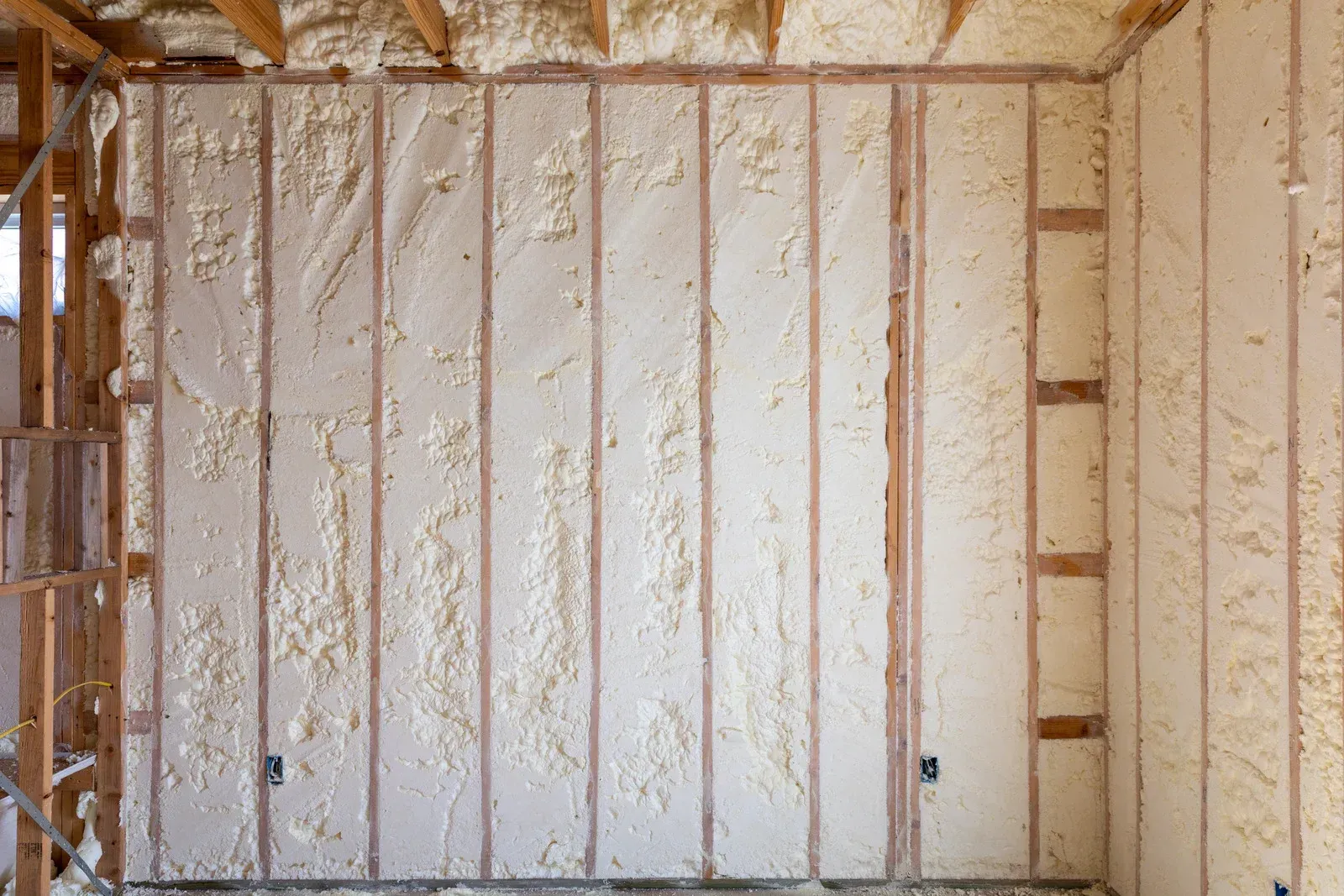 A room with foam insulation on the walls and ceiling.