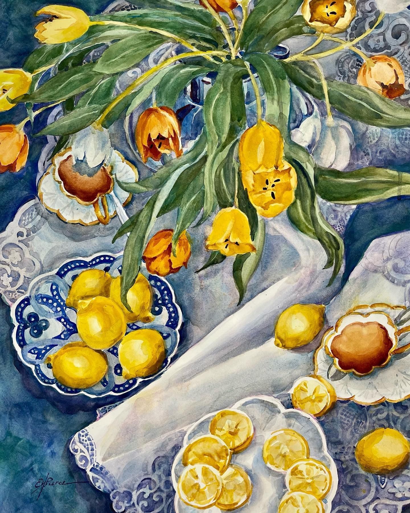 Watercolor still life: Yellow tulips, lemons on blue and white plates, and lace on a blue background.