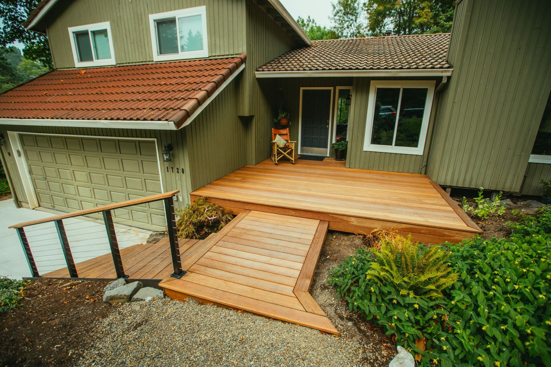 A house with a wooden deck and stairs leading up to it