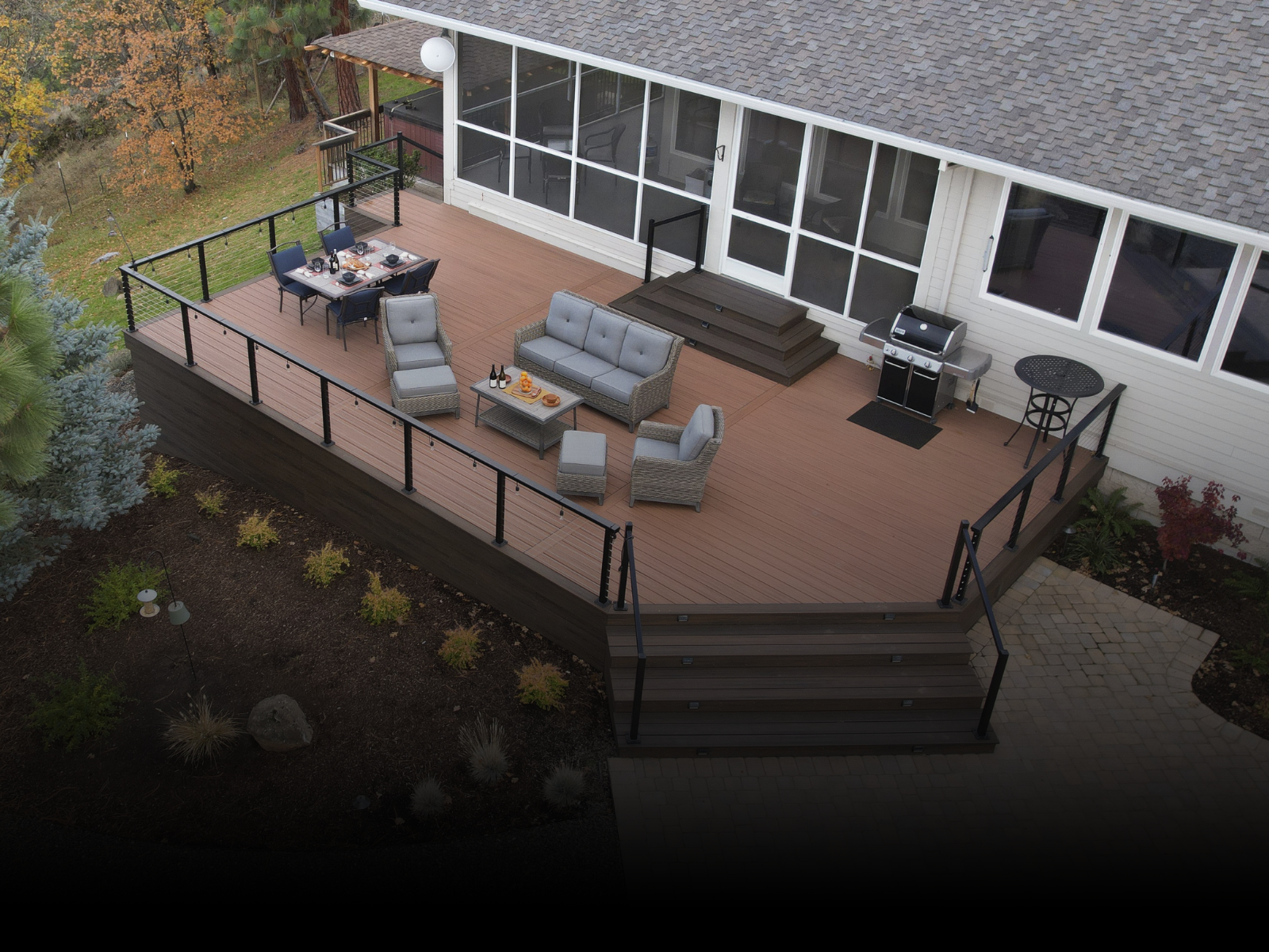 An aerial view of a deck with furniture and a grill