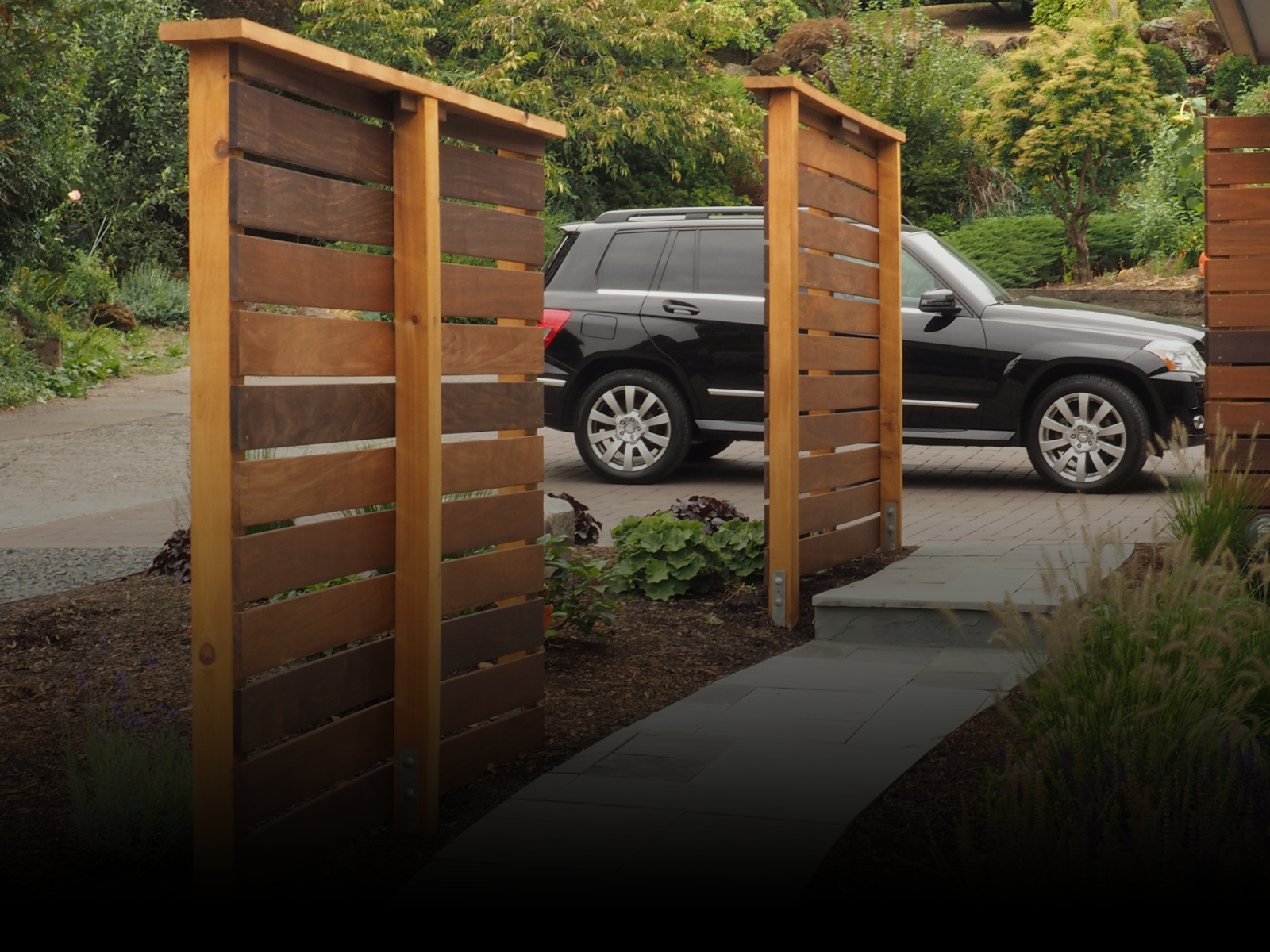 Custom wood privacy panels in front of a house in Southern Oregon