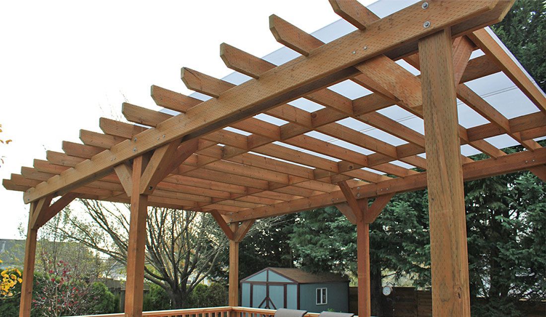 A wooden pergola with a clear plastic roof