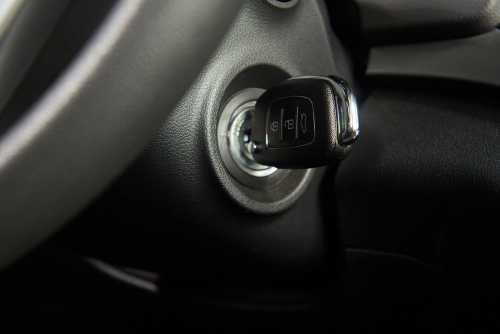 Car Key Inserted in the Ignition. Black Key, Grey Dashboard — H & E Auto Electrics in Noosaville, QLD
