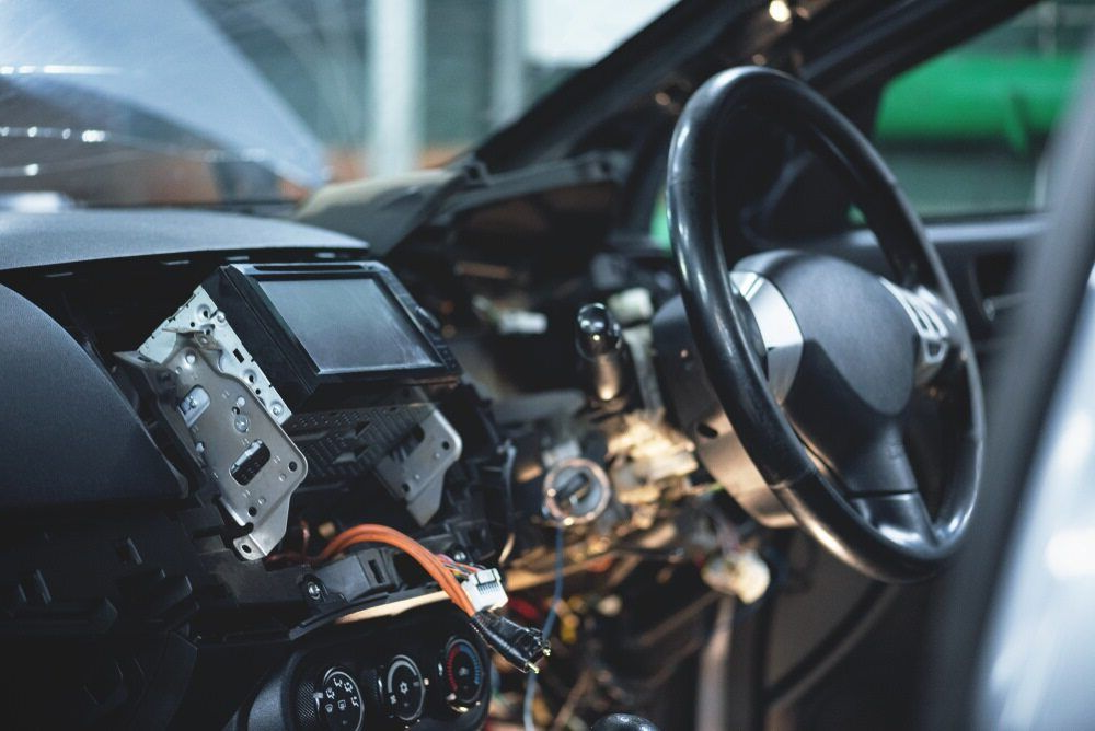 Car Interior Being Worked on, Dashboard Disassembled, Steering Wheel Visible — H & E Auto Electrics in Noosaville, QLD
