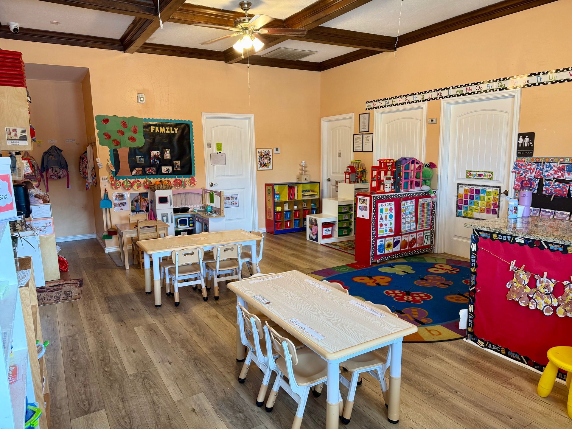 A classroom with a table and chairs in it.