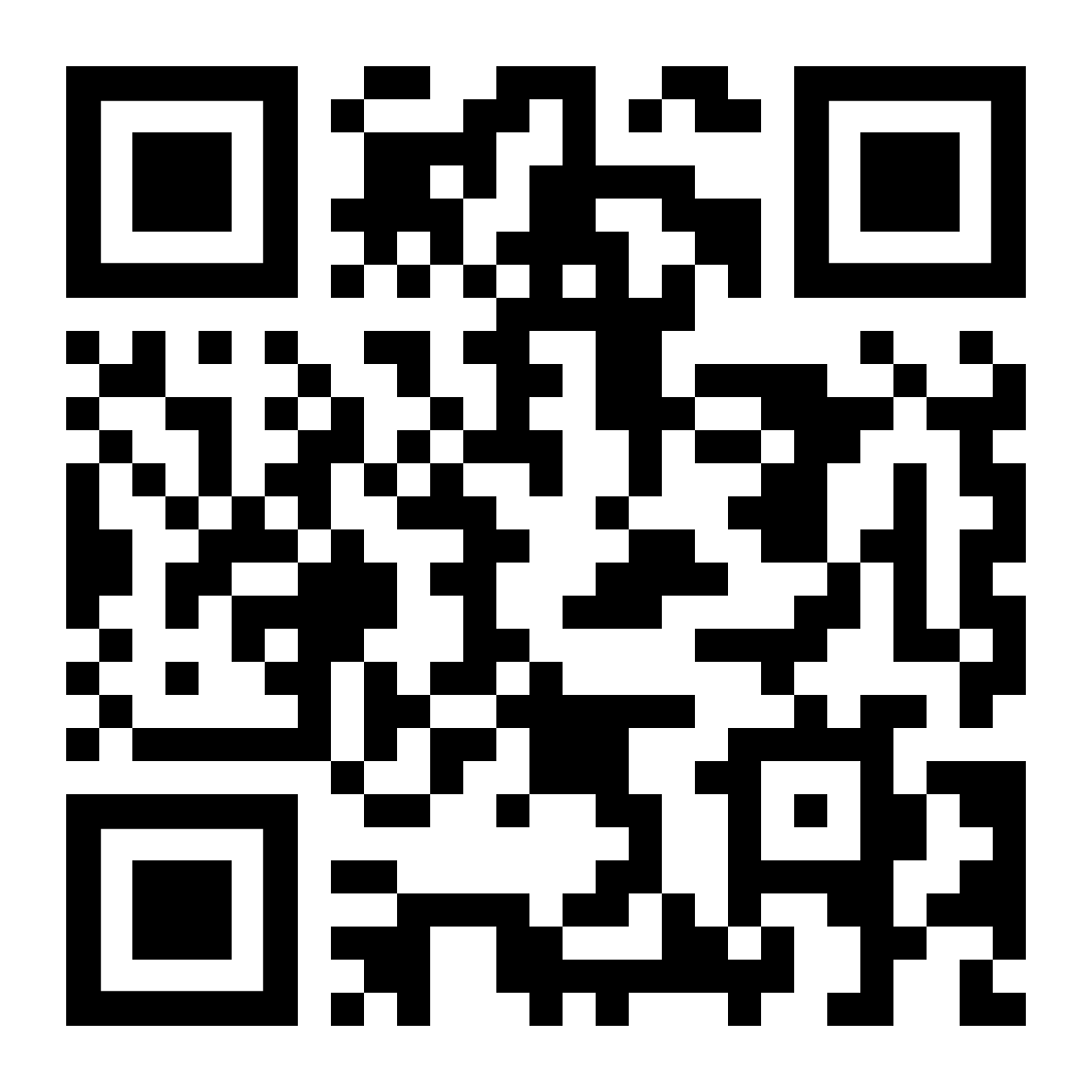 A baby is standing in front of a mirror and smiling