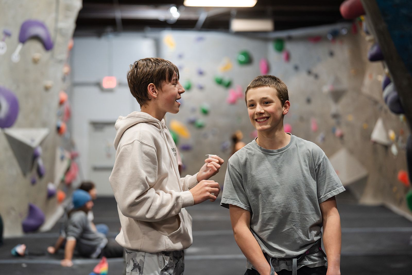 Person helps with climbing harness
